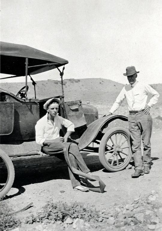 Jack, Louis' adopted brother, and Dr. L.C. LaMoore changing a flat tire.