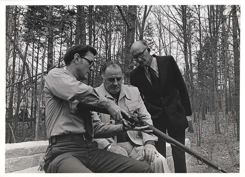 Louis, a Park Ranger and Reese Hawkins examine an original Fergusson Rifle.
