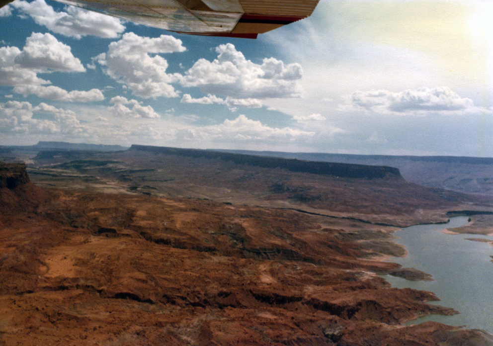 Louis scouts No Man's Mesa from the air. Related to HAUNTED MESA.