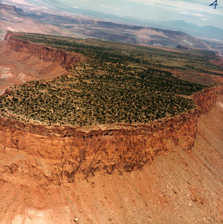 Louis scouts No Man's Mesa from the air. Related to HAUNTED MESA.