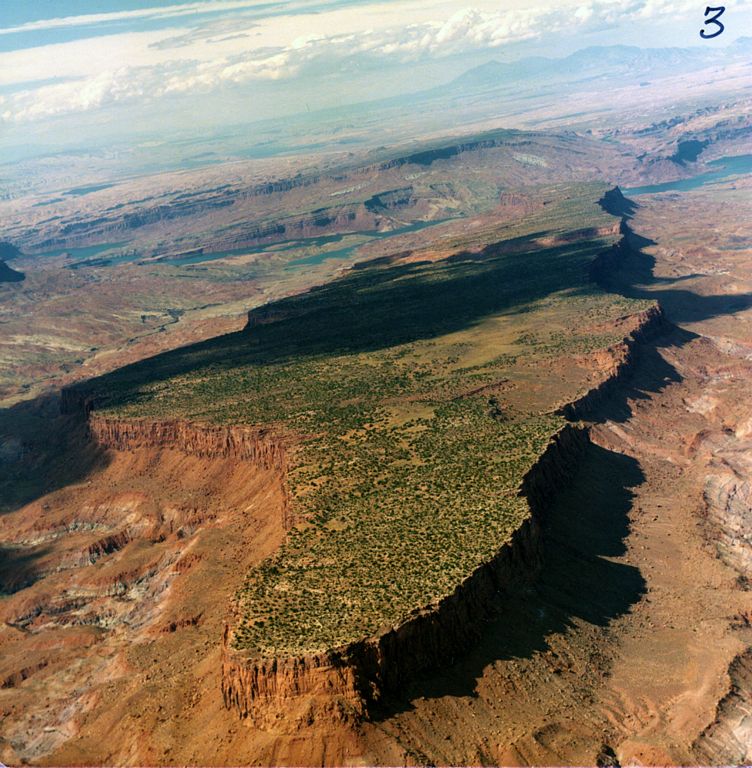 Louis scouts No Man's Mesa from the air. Related to HAUNTED MESA.